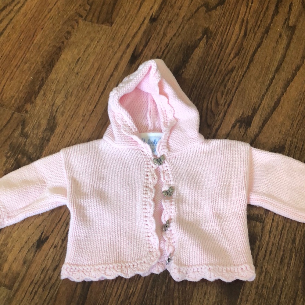 Pink cardigan with bow details at buttons